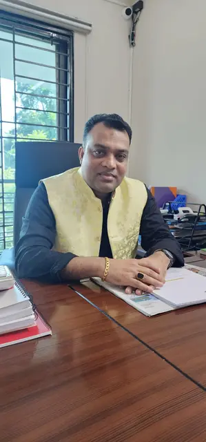 Abdul Kader Chowdhury at his office desk